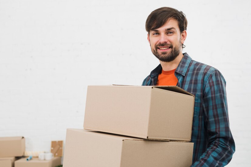 portrait young man carrying cardboard boxes looking camera against white background_23 2148095494